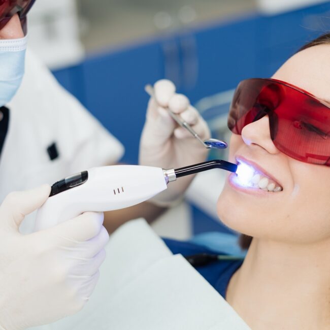 Young woman getting laser dental treatment at at Advanced Care Dentistry in Scottsdale AZ